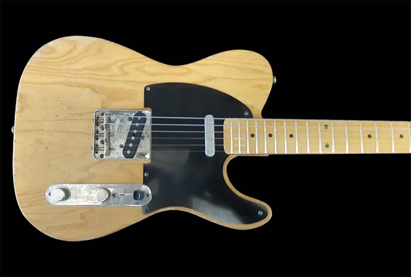 Natural wood body with black pick guard.